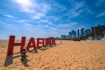 Busan, Korea - February 21, 2020  Text â HAEUNDAE â on Haeundae beach with busan city at daytime on Busan, South Korea.のeditorial素材