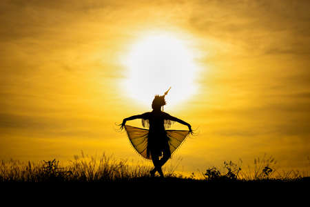Silhouette Manohra women dance with sunset in South of Thailand.の写真素材