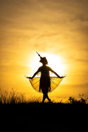 Silhouette Manohra women dance with sunset in South of Thailand.の写真素材