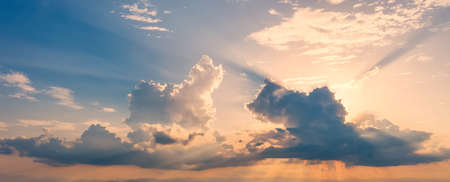 Colorful dramatic sky with sunlight and cloud at sunset.の写真素材