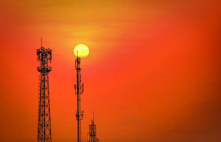 Silhouette telecommunications antenna for mobile phone at sunsetの写真素材