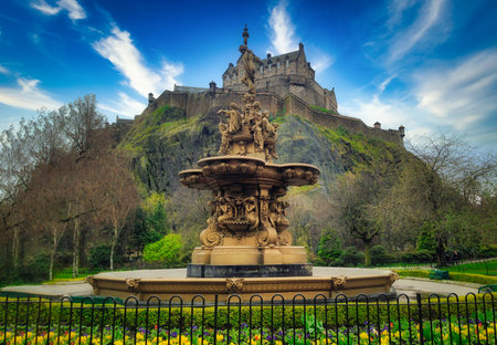 Ross Fountain in garden with Edinburgh Castle on blue sky at United Kingdomのeditorial素材