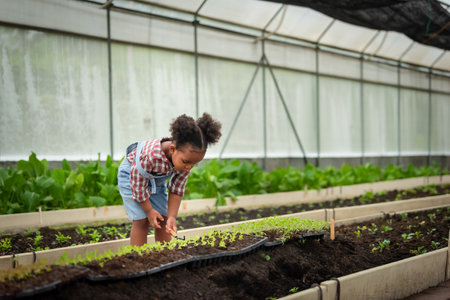 Portrait of African children plant seedlings in greenhouse
