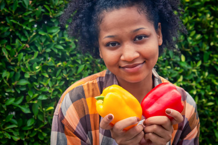 Happy teenager holding vegetable at fall day in organic farm. Harvesting on the farm. Vintage toneの写真素材