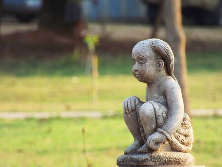 Statue of a child sat sadly の写真素材
