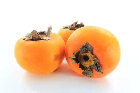 the persimmon three balls resting on a white background.の写真素材