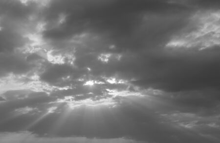 Sun brighter behind the black clouds.の写真素材