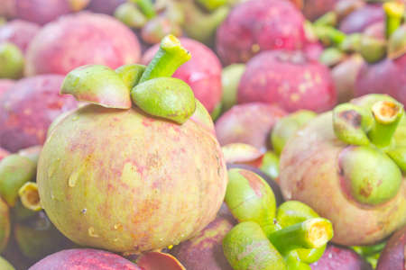 The raw mangosteen is placed in the basket.の写真素材