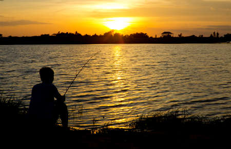 Men are fishing by the lake.の写真素材