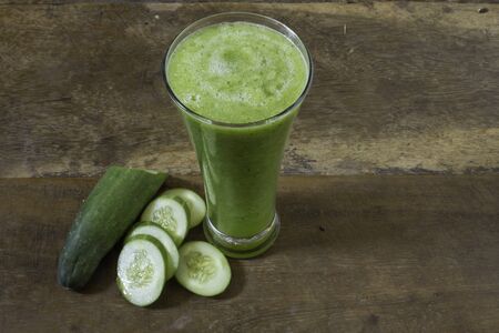 Cucumber juice placed on a wooden floorの写真素材