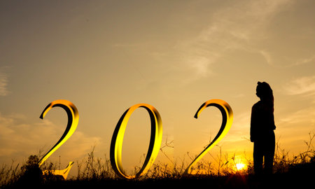 Silhouette boy watching the sunrise on New Year 2021,concept Success new year.