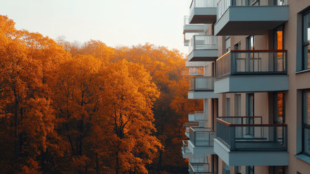 Minimalist apartment buildings with scenic balconies, overlooking a peaceful autumn forest in a sustainable neighborhood.の素材