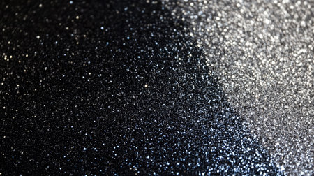 Elegant black to silver glitter texture gradient with fine sparkling dust, creating a sophisticated abstract background.の素材