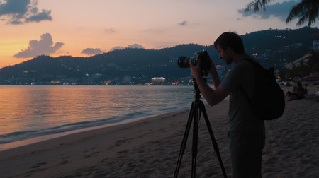 Tourist taking sunset photos on Patong Beach with pastel-colored sky and calm sea as a backdropの素材