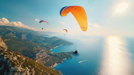Paragliders soaring in the sky over a picturesque landscapeの素材