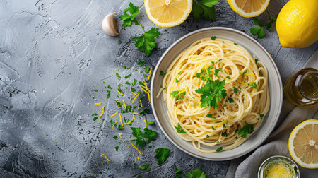 Top view of spaghetti with lemon and garlic sauce, garnished with parsley and lemon zest.の素材