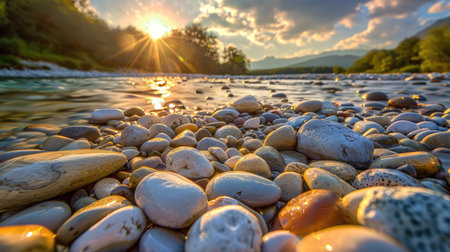 A serene riverbed filled with smooth, colorful pebbles, glistening under the sunlight.の素材