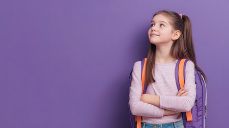 Preteen girl with a backpack, lost in thought and smiling softly. Perfect for ads and content about education and childhood. Lilac violet background.の素材