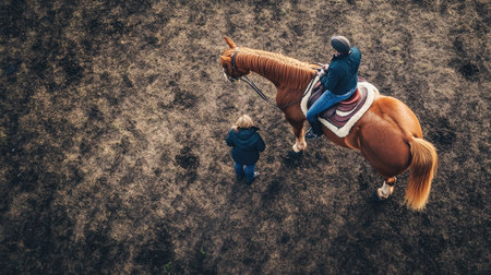 Aerial view of a horse being saddled by its owner, ready for an afternoon ride.の素材