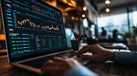 A financial analyst, using a sophisticated software program to analyze market data.の素材