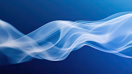 White smoke billowing in elegant curves against a deep blue background, creating an abstract, mysterious atmosphere.の素材