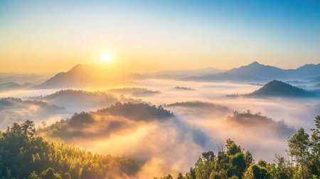 Experience the tranquil beauty of a sunrise illuminating misty mountains. This serene landscape captures the essence of nature's peaceful moments at dawn.の素材