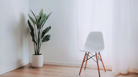 A bright and minimalist interior scene featuring a modern chair and a leafy plant, perfect for showcasing tranquility and contemporary home design.の素材