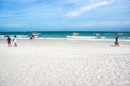 White beach green sea under blue sky