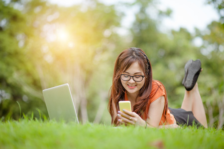Young beautiful Asian woman working at outdoor park,happy relaxing. owner business woman work  at...