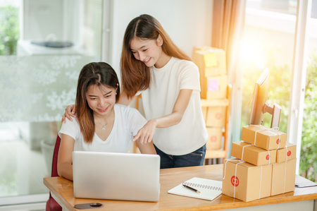 Two beautiful women owner business woman work at home for online shopping .online business conceptの写真素材