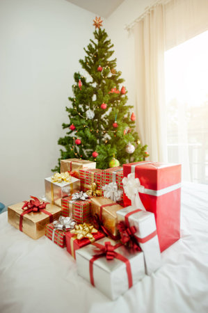 Christmas tree and many present boxes.in bedroom.の写真素材