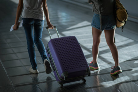 woman carries luggage at the airport terminal.の写真素材