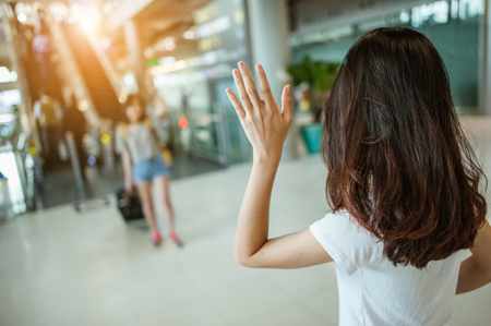 Asian girl Will be embracing friends from abroad.airports concept.airports hug.の写真素材