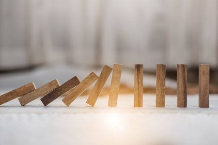 domino effect made up from wooden blocks shape toy.domino effect in business concept.the domino wooden effect concept for business.の写真素材