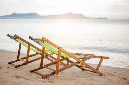 Bright color wooden beach chairs on island tropical beachの写真素材