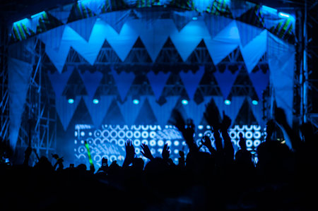 silhouettes of hand in concert.Light from the stage.の写真素材