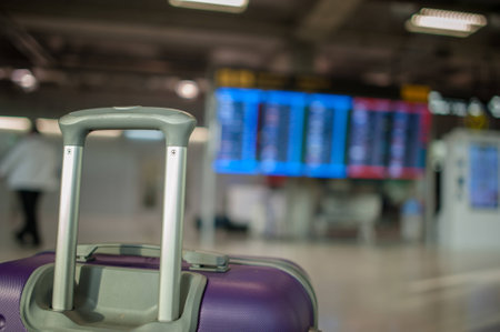 close up  baggage for check in at flight timetable in international airport.