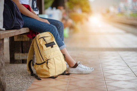 Traveler woman  waits train on railway platform.