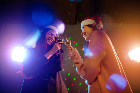 Christmas party cheerful friends at having drink and funの写真素材