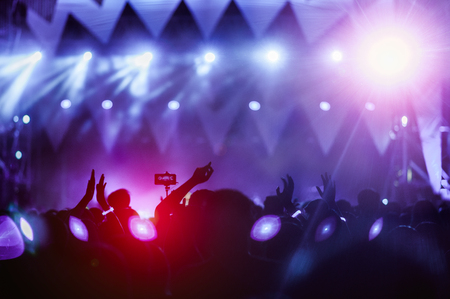 silhouettes of hand in concert.Light from the stage.の写真素材