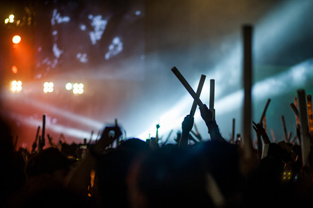 silhouettes of hand in concert.Light from the stage.の写真素材
