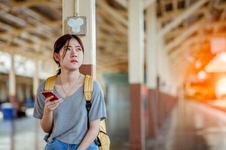 Woman use smartphone in a train stationの写真素材
