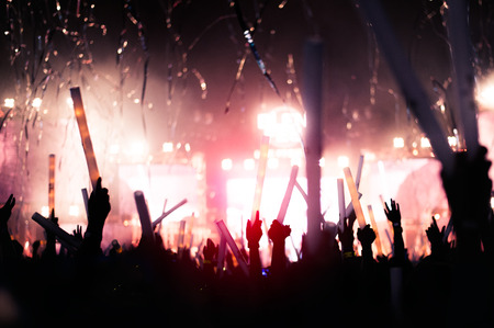 silhouettes of hand in concert.Light from the stage.の写真素材