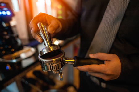 Barista making coffee. yellow coffee making machine close-up.Barista prepares espresso in his coffee shop close-upの写真素材