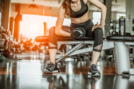 Bodybuilder working out with dumbbell weights at the gym.man bodybuilder doing exercises with dumbbell. Fitness muscular bodyの写真素材
