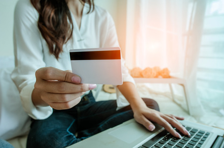 Hands holding credit card and using laptop. Online shoppingの写真素材