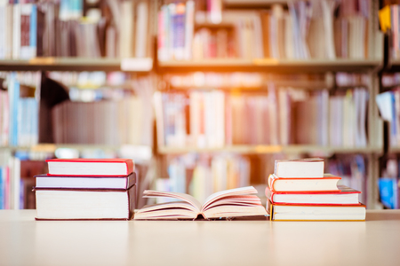 Book stack is placed on the library desk. education background, back to school concept.の写真素材