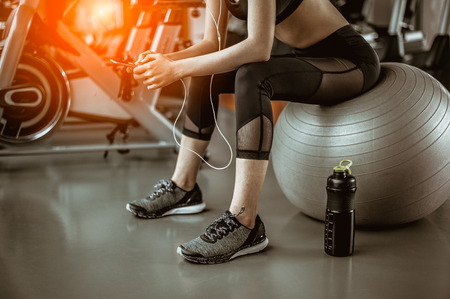 Portrait of Fitness woman  in gym listening to music.exercising concept.fitness and healthy lifestyleの写真素材