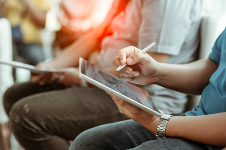 close up hands multitasking man using tablet connecting wifi. Business Project.Touching Screen Digital Tablet. Horizontal. Film effect. Blurred background. Flaresの写真素材