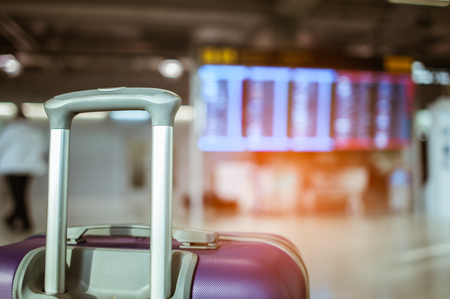 close up baggage for check in at flight timetable in international airport.の写真素材